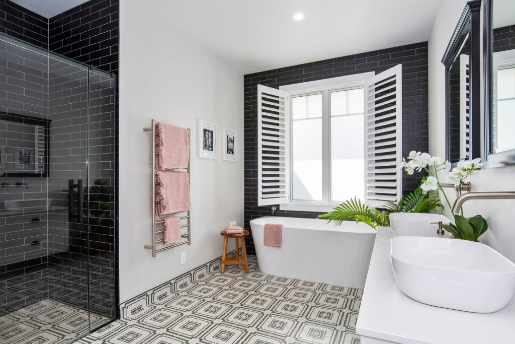 Stunning full bathroom scene with tiled floor and shower and alfresco windows above the bath