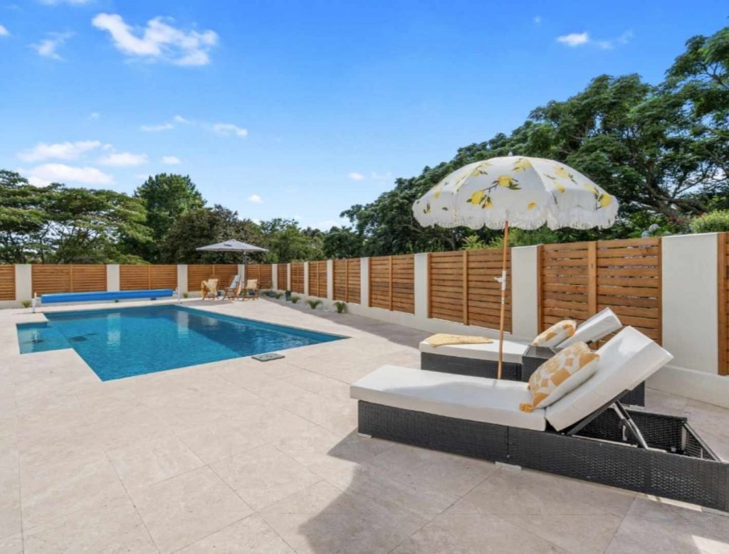 Beautiful outdoor setting of a renovated tiled pool patio area